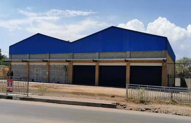 Bâtiment de magasin en acier de construction d'atelier de construction préfabriquée de structure métallique de ferme de stockage en métal préfabriqué d'entrepôt au Botswana
